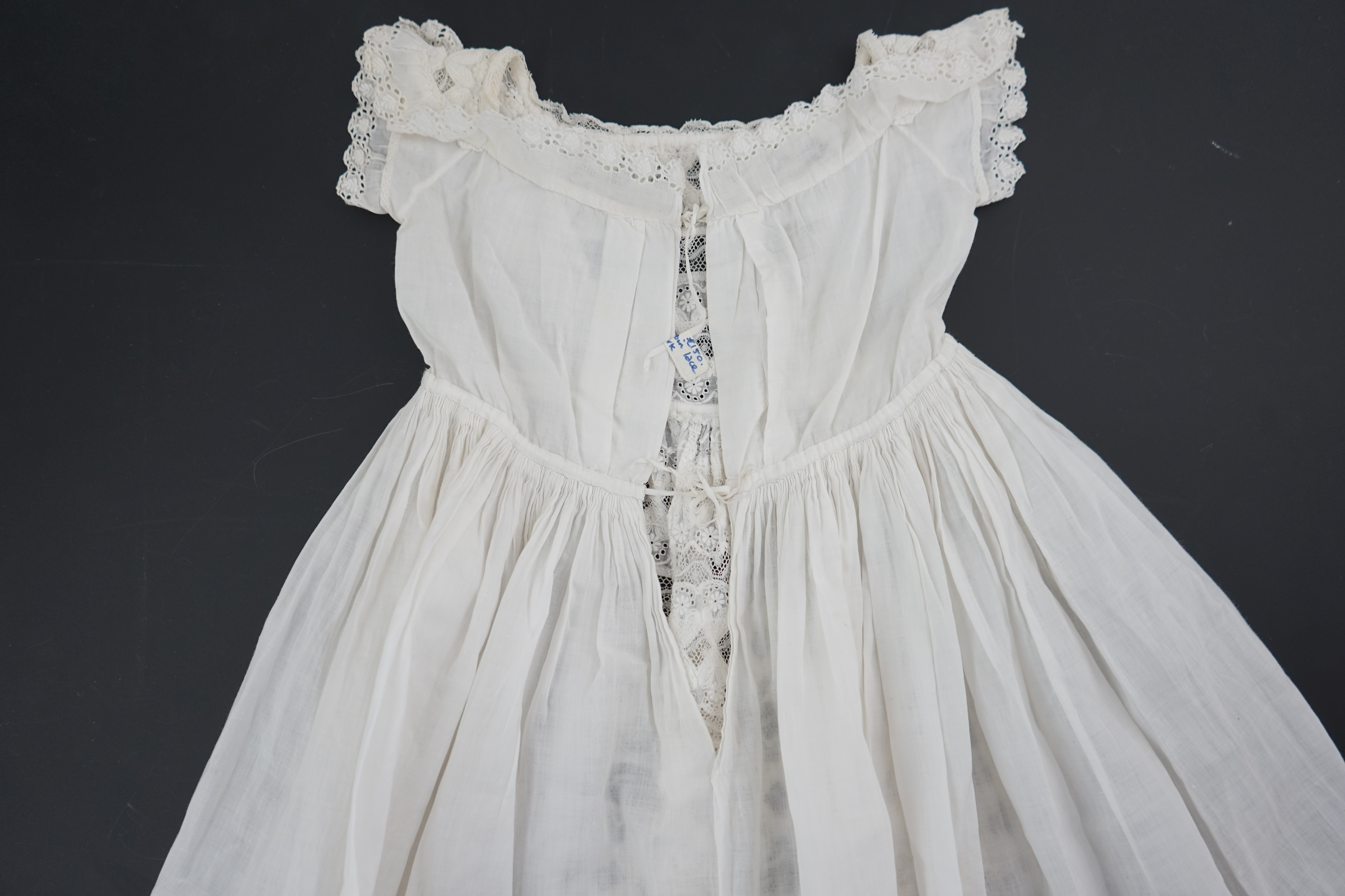 Two unusual 19th century intricately white worked children’s dresses, one hand worked with fine panels of white work, feather stitching and tucking, edged and inserted with hand made Valenciennes lace, the other worked i